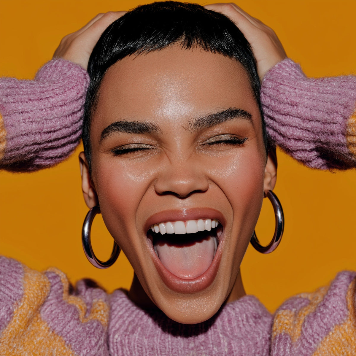Woman with short hair and hoop earrings wearing a pink sweater against an orange background
