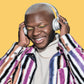 Man wearing headphones with a colorful striped coat on a yellow background