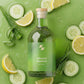 Bottle of 'Mineral Restore' on a green background with cucumber slices, lemon wedges, and aloe vera.
