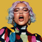 Person with colorful hair and clothing against a yellow background